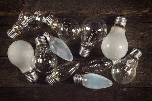 istock Lightbulbs on wooden background 1179870852
