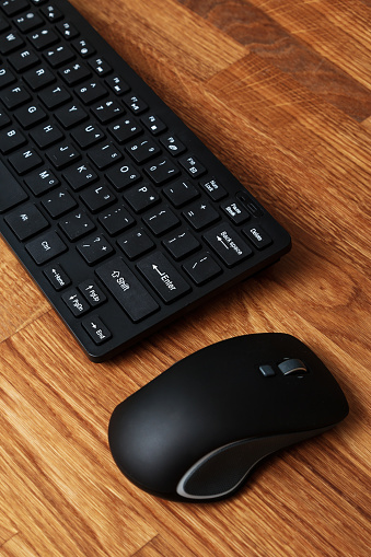 Keyboard and mouse on wooden table