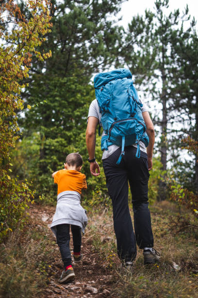 istock Father and son hiking and exploring forest together 1179878035