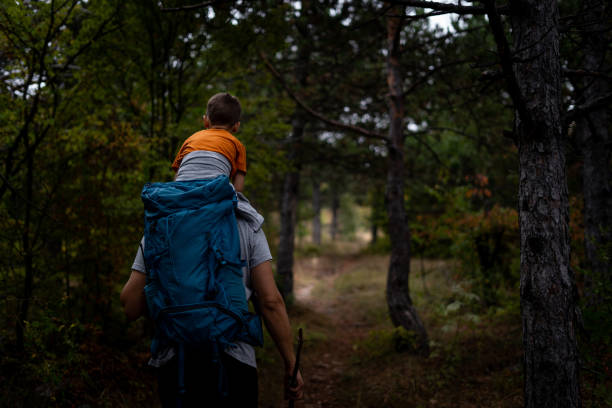 istock Father and son hiking and exploring forest together 1179878832