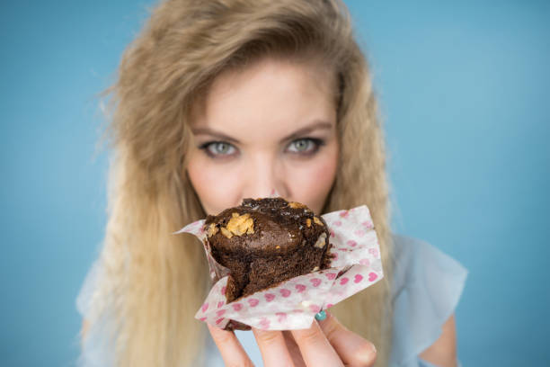 istock Attractive woman holds cake in hand 1179880060