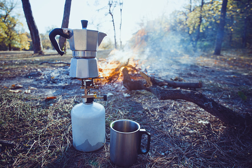 happy trip - bonfire and geyser coffee maker in the foreground 