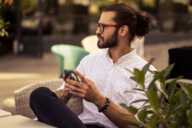 istock Young hipster person sitting at cafe, and surfing the net 1179881114