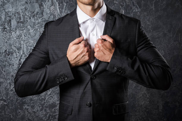 istock Man in suit against concrete wall 1179881885