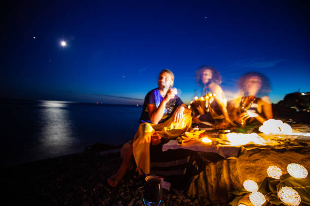 istock Motion Blurred Couple on Beach at Night 1179882288
