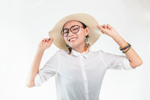 Picture of an Asian woman in a smiling and happy mood on a white background.Focus on face