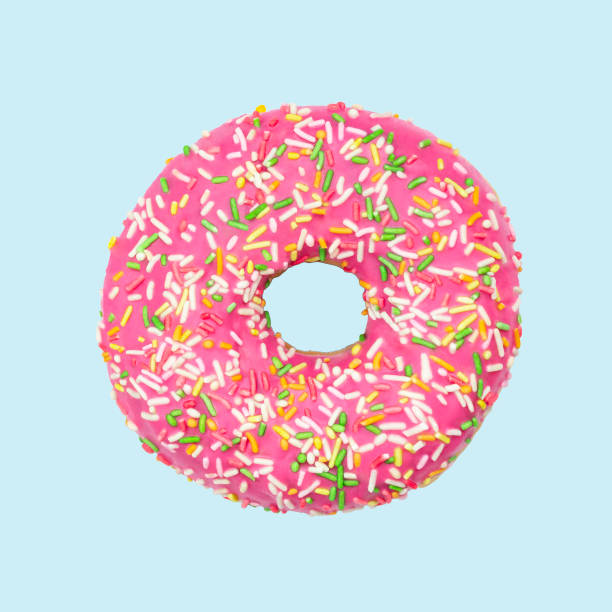 istock Donut isolated on blue background. Sweet pink sugar icing doughnut. strawberry donuts top view. break time. 1179885035