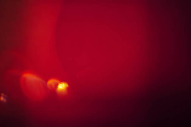 istock maroon red art background lens flare yellow drops 1179885068