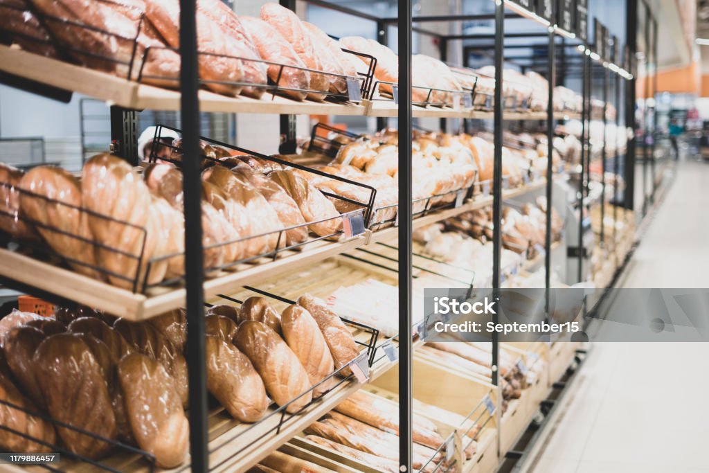 Bakery showcase. Freshly baked bread. Presentation of bread in a shop window of a hypermarket. Bakery showcase. Freshly baked bread. Presentation of bread in a shop window of a hypermarket Supermarket Stock Photo
