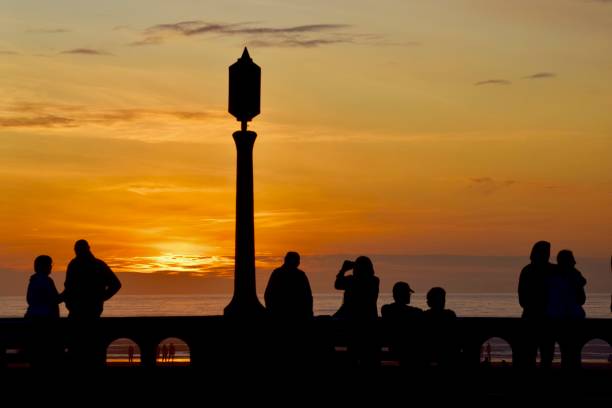Seattle, USA - Feb 12th, 2023: A vivid sunset over Elliott Bay from the Seattle Aquarium on the waterfront.