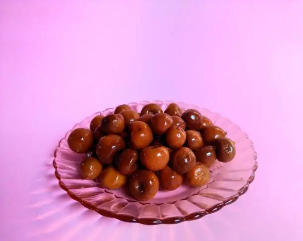 Photo of Sweet nanche on pink background. Typical sweet from Guatemala. food concept