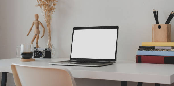 istock Minimal office room with blank screen laptop computer with books and office supplies 1179905427