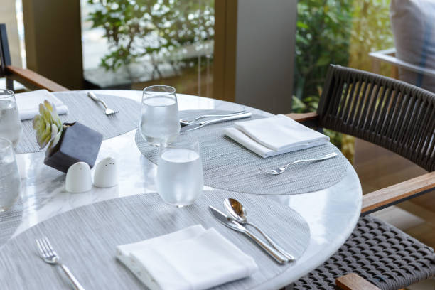 istock Table setting in the restaurant. Decorated elegant table, glasses, napkin, knife, fork and spoon 1179905605