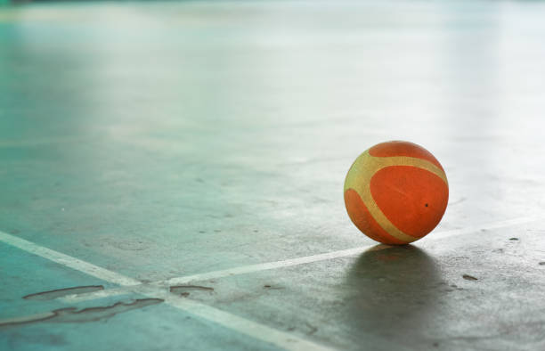 istock Old basketball ball on the field floor 1179911169