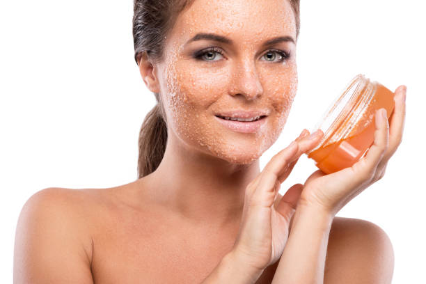 istock Young beautiful woman with sugar scrub on her face 1179922418