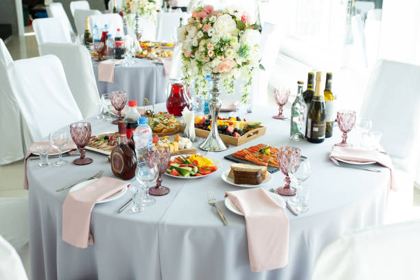 istock A wedding table for guests decorated with flowers and a tablecloth in a designer style with food and drinks. Decor and design of events, catering. 1179923112