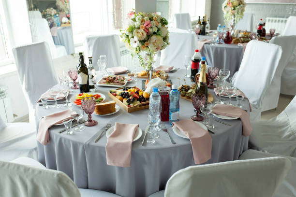 istock A wedding table for guests decorated with flowers and a tablecloth in a designer style with food and drinks. Decor and design of events, catering. 1179923194