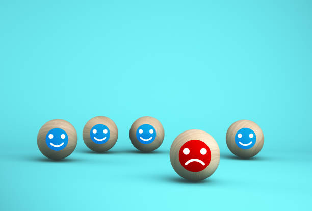istock Abstract of face emotion happiness and sadness, Unique, think different, individual and standing out from the crowd concept. Wooden sphere with icon on blue background. 1179928112