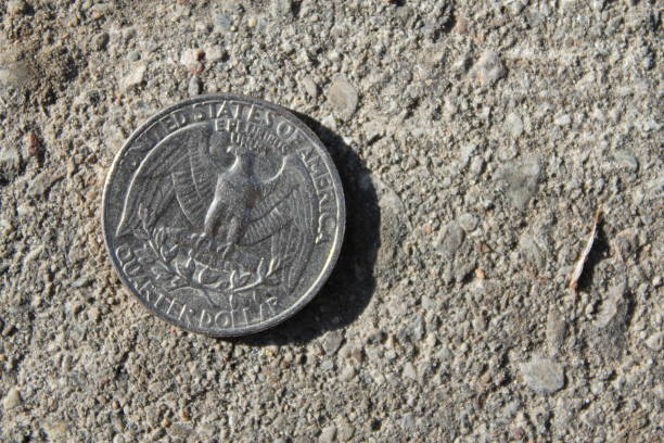 istock Old American Coin Eagle tails up on a sidewalk 1179929493