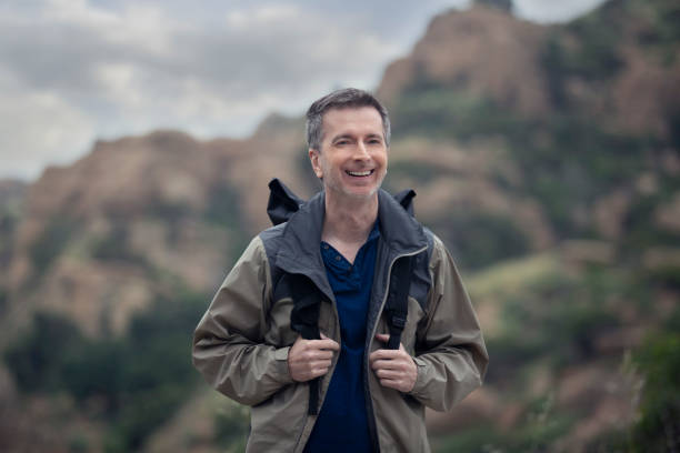 istock Middle Aged Caucasian Man Hiking Alone in the Mountains 1179929822