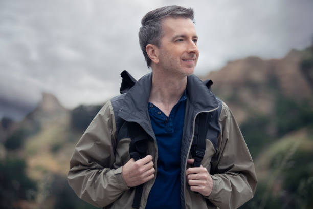 istock Middle Aged Caucasian Man Hiking Alone in the Mountains 1179929828