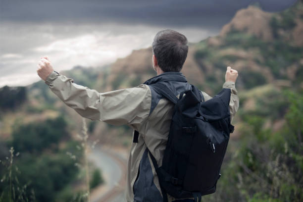 istock Middle Aged Caucasian Man Hiking Alone in the Mountains 1179929849