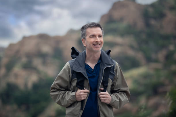 istock Middle Aged Caucasian Man Hiking Alone in the Mountains 1179929903