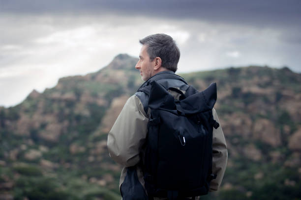istock Middle Aged Caucasian Man Hiking Alone in the Mountains 1179929905