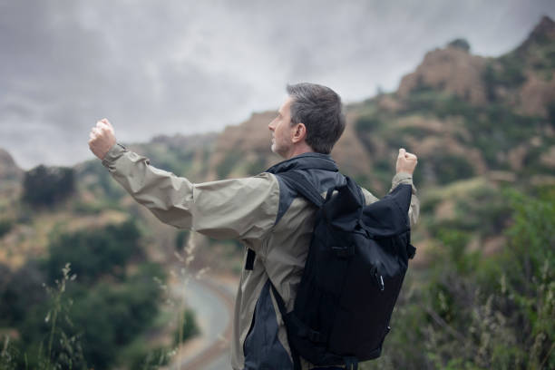 istock Middle Aged Caucasian Man Hiking Alone in the Mountains 1179929924