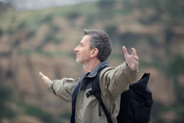 istock Middle Aged Caucasian Man Hiking Alone in the Mountains 1179929925