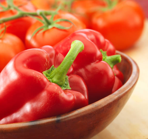 istock Capsicum in wooden bowl with Tomatoe's 1179931270