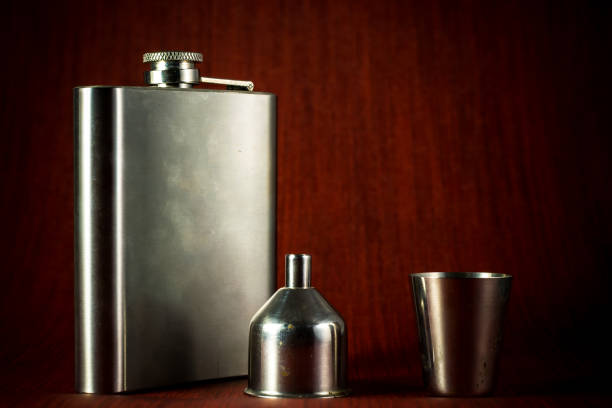 Metallic container for liquid, alcohol, whiskey and cognac. Old classic pocket vessel.