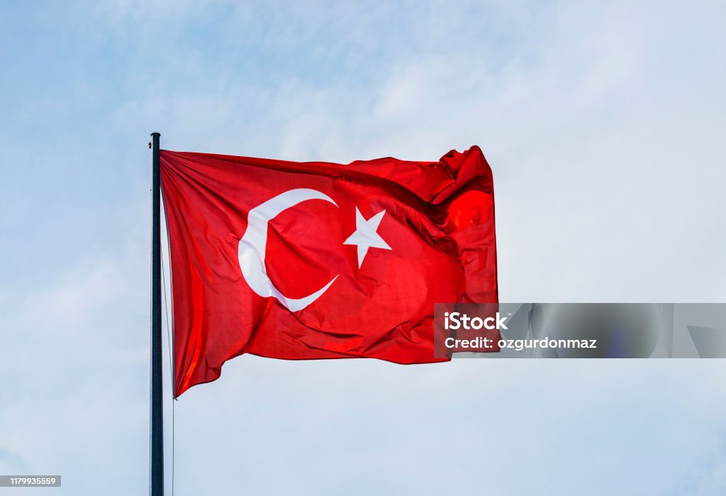 Turkish flag, cloudy sky Turkish Flag Stock Photo