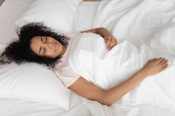 istock Calm tired black girl sleeping in white bed 1179938824