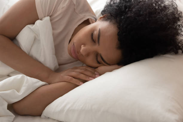 istock Tired black woman relax sleeping in comfortable bed 1179938826