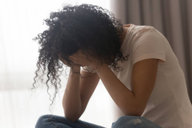 Upset black woman crying suffering from relationships problems Depressed african American young woman sit at home feel desperate down suffering from relationships problems breakup, upset black girl crying having life troubles, miscarriage or abortion concept miscarriage stock pictures, royalty-free photos & images