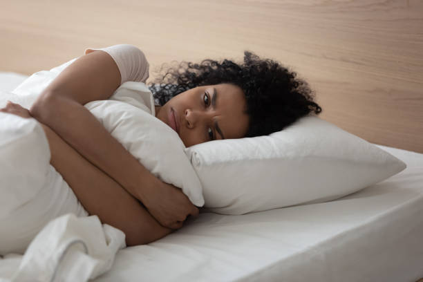 istock Mad black woman lying in bed feeling upset 1179938839