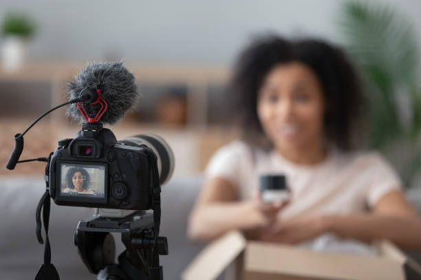 istock Professional camera shooting black female unpacking vlog 1179938840