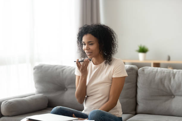 istock Black young woman using digital assistant on smartphone 1179938869