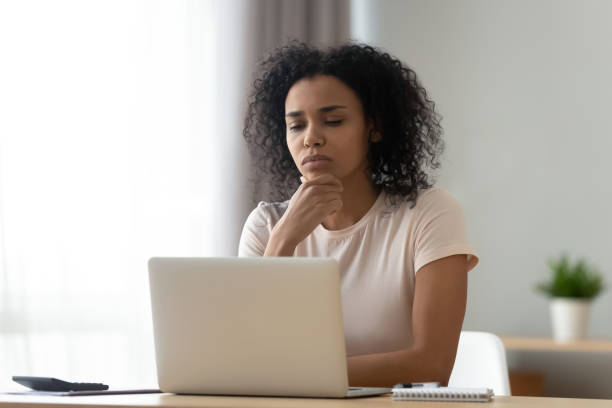 istock Pensive biracial woman thinking working on laptop 1179938905
