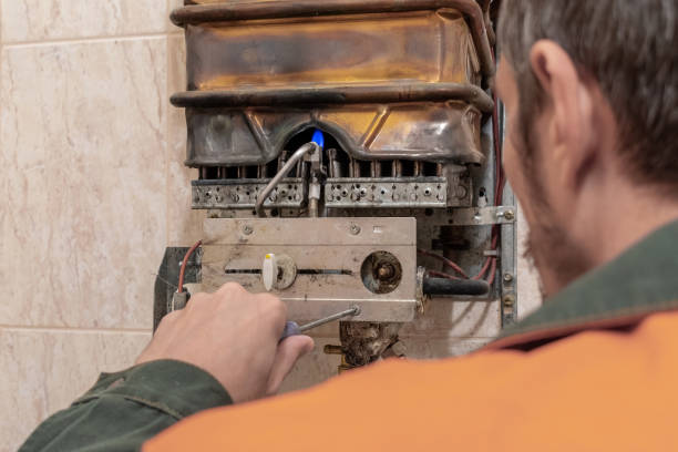 istock master performs maintenance of the gas boiler. 1179940108