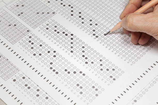 istock students hand doing exams quiz test paper 1179941527