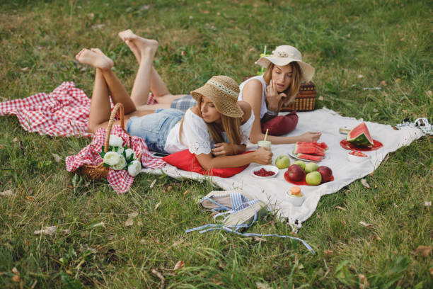 istock Women having a picnic in the park 1179942535