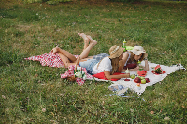 istock Women having a picnic in the park 1179942536