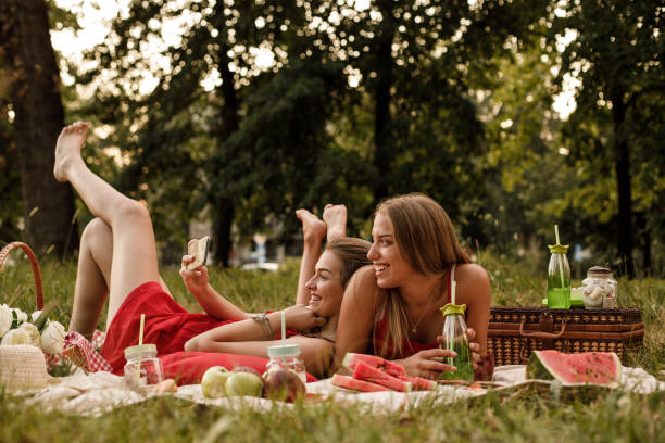 Young women taking selfie during a picnic in nature