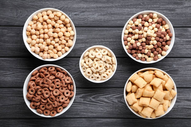 istock Various corn flakes in bowls on black wooden table 1179942853