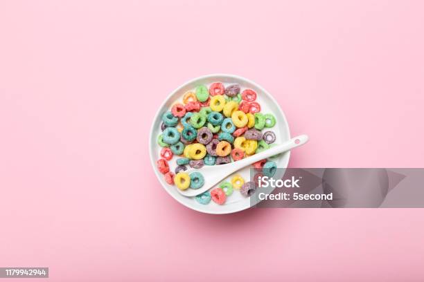 Colorful Corn Rings In Bowl With Milk And Spoon On Pink Background Stock Photo - Download Image Now