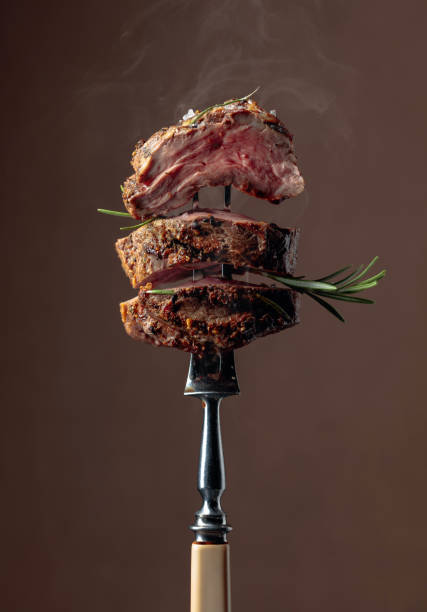 istock Grilled ribeye beef steak with rosemary on a brown background. 1179945496