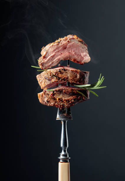 istock Grilled ribeye beef steak with rosemary on a black background. 1179945507