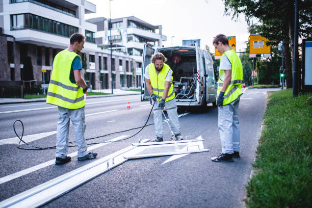 istock Road Surface Marking Crew Repainting Turn Arrow 1179947038